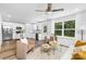 Inviting living room open to the kitchen with lots of natural light, modern furniture, and wood floors at 4474 Pebblebrook Sw Cir, Concord, NC 28027