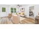 Bright living room with stylish furnishings, wood floors, large window and access to the Primary bedroom at 4474 Pebblebrook Sw Cir, Concord, NC 28027