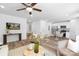 Open-concept living room and kitchen area with hardwood floors, modern decor, and stainless steel appliances at 4474 Pebblebrook Sw Cir, Concord, NC 28027