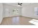 Bright living room showcasing light hardwood floors, a ceiling fan, and white painted walls at 455 Contentment Ct # 18, Kannapolis, NC 28081