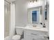 Clean bathroom with gray walls, white vanity, and shower with white curtain at 5909 Cougar Ln, Charlotte, NC 28269
