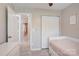 Bright bedroom with neutral walls, tiled floors, large closet, and bed near the wall at 5909 Cougar Ln, Charlotte, NC 28269