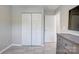 Bright bedroom with large closet, tile floor, and adjacent bathroom at 5909 Cougar Ln, Charlotte, NC 28269