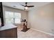 Bedroom featuring tile flooring, ceiling fan, large window, and fitness equipment at 5909 Cougar Ln, Charlotte, NC 28269