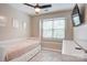 Cozy bedroom featuring a daybed, ceiling fan, and natural light from a window at 5909 Cougar Ln, Charlotte, NC 28269