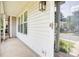 A home entrance featuring a concrete porch, painted rails, and outdoor lighting at 5909 Cougar Ln, Charlotte, NC 28269