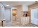 Convenient laundry room with coffee bar, white cabinets, and a sliding glass door for natural light at 5909 Cougar Ln, Charlotte, NC 28269