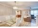 Open-concept living and dining area with modern lighting, wainscoting, and stylish decor at 5909 Cougar Ln, Charlotte, NC 28269