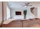 Cozy living area with a large sectional sofa, ceiling fan, and a mounted TV for entertainment at 5909 Cougar Ln, Charlotte, NC 28269