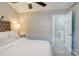 Inviting bedroom featuring neutral walls, ceiling fan, and doorway leading to hall at 5909 Cougar Ln, Charlotte, NC 28269