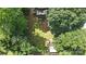 Aerial view of a lush backyard with a shade trees, garden boxes, and a fire pit at 602 Unity St, Fort Mill, SC 29715