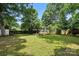 Green backyard featuring a shed, providing ample storage space and a view of the wooden fence at 602 Unity St, Fort Mill, SC 29715