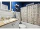 Cozy bathroom featuring shiplap walls, floating shelves, and a shower-tub combo at 602 Unity St, Fort Mill, SC 29715