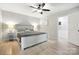 Bright bedroom with a ceiling fan, ensuite bathroom, and whitewashed wood bed frame at 602 Unity St, Fort Mill, SC 29715