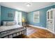 Comfortable bedroom with blue walls, hardwood floors, and two windows at 602 Unity St, Fort Mill, SC 29715