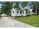 Charming single-story home featuring a well-manicured lawn and a convenient private driveway at 602 Unity St, Fort Mill, SC 29715