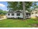 Charming single-story home with light gray siding, black shutters, and well-manicured lawn at 602 Unity St, Fort Mill, SC 29715