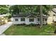 Charming single-story home featuring a well-manicured lawn and lovely landscaping at 602 Unity St, Fort Mill, SC 29715