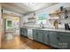 Bright kitchen boasts open shelving, updated appliances, and a view to the outdoors at 602 Unity St, Fort Mill, SC 29715