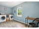 Bright laundry room featuring modern washer and dryer units with a small desk at 602 Unity St, Fort Mill, SC 29715