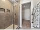 Modern bathroom showcasing a glass-enclosed shower with tiled walls and convenient built-in shelving at 626 Wabash Ave # 6, Charlotte, NC 28208