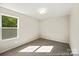 Well-lit bedroom with neutral walls and carpet, and a window offering green outdoor views at 626 Wabash Ave # 6, Charlotte, NC 28208