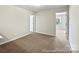 Bedroom with neutral carpet and a door leading to another room, offering versatile living space at 626 Wabash Ave # 6, Charlotte, NC 28208