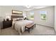 Cozy bedroom with neutral decor, comfortable bed, and windows offering a peaceful view at 626 Wabash Ave # 6, Charlotte, NC 28208