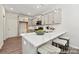 Modern kitchen with gray cabinets, stainless steel appliances, and a quartz countertop island with seating at 626 Wabash Ave # 6, Charlotte, NC 28208