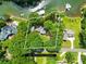 Aerial view of a beautiful home with mature trees on a waterfront lot with a private dock at 698 Normandy Rd, Mooresville, NC 28117