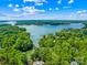 Expansive aerial view showcasing the lake and the lush green landscape at 698 Normandy Rd, Mooresville, NC 28117