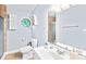 Bathroom featuring tiled shower, custom octagon window, and a modern sink at 698 Normandy Rd, Mooresville, NC 28117