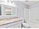 Bright bathroom featuring vanity sink with granite countertops, a toilet, and shower-tub combination at 698 Normandy Rd, Mooresville, NC 28117