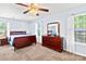 Sunlit bedroom with neutral walls, plush carpeting, and ample natural light from two windows at 698 Normandy Rd, Mooresville, NC 28117