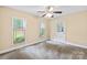 Bedroom featuring neutral carpet, a door to the exterior, and large windows for plenty of light at 698 Normandy Rd, Mooresville, NC 28117