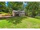 Lakefront property featuring a well-maintained lawn and a scenic view at 698 Normandy Rd, Mooresville, NC 28117