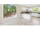Bright kitchen featuring white cabinetry, dark granite countertops, and a large window at 698 Normandy Rd, Mooresville, NC 28117