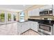 Modern kitchen with an island, stainless steel oven, and view from large windows at 698 Normandy Rd, Mooresville, NC 28117