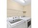 Laundry room equipped with white appliances and a wire rack for additional storage at 698 Normandy Rd, Mooresville, NC 28117
