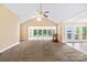 Spacious living room with carpet, high ceiling, and expansive lake views at 698 Normandy Rd, Mooresville, NC 28117