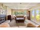 Cozy living room featuring a fireplace, a large window view, and comfortable furniture at 698 Normandy Rd, Mooresville, NC 28117