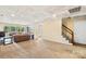 Open living area with large windows offering scenic views and stairs to a second story at 698 Normandy Rd, Mooresville, NC 28117