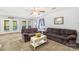 Comfortable living room featuring neutral paint, plush seating, and seamless access to the screened-in porch at 698 Normandy Rd, Mooresville, NC 28117