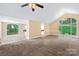 Open living area with vaulted ceilings, large windows, and access to the kitchen at 698 Normandy Rd, Mooresville, NC 28117