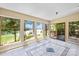 Beautiful sunroom with tile floors, multiple windows, and lake views at 698 Normandy Rd, Mooresville, NC 28117