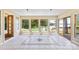 Inviting sunroom with tile flooring, natural light, and scenic lake views at 698 Normandy Rd, Mooresville, NC 28117