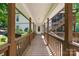 Covered walkway leading to the front door with wooden railings and stairs on the right side at 698 Normandy Rd, Mooresville, NC 28117