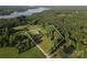 Aerial view highlighting the property's land and natural surroundings, including a nearby lake at 746 Joe Lentz Rd, Salisbury, NC 28146