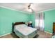 Bedroom featuring carpet flooring, a ceiling fan, mint green walls, and a window with curtains at 746 Joe Lentz Rd, Salisbury, NC 28146