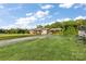 Charming single-story home with a covered parking area surrounded by a well-manicured lawn and trees at 746 Joe Lentz Rd, Salisbury, NC 28146